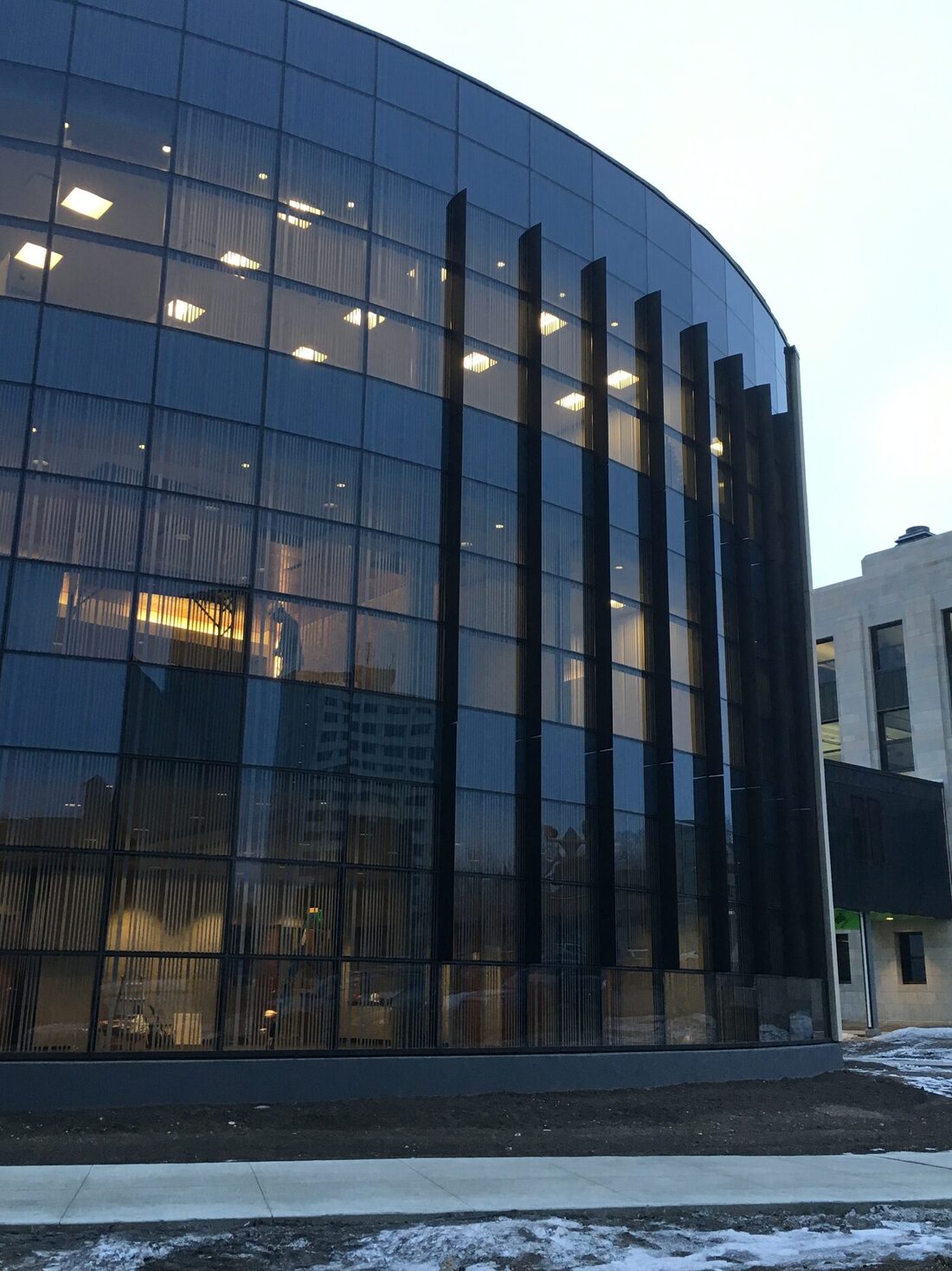 Curved glass curtainwall facade at dusk